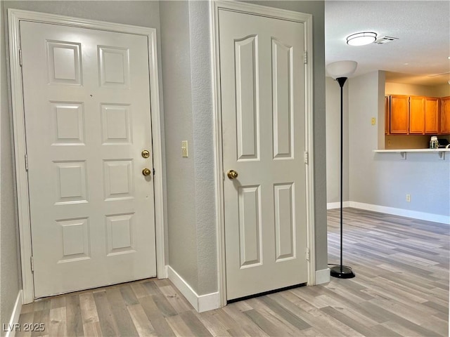 2627 S Durango Dr Unit 202, Las Vegas, NV 89117 - foyer with light wood-type flooring and a textured wall