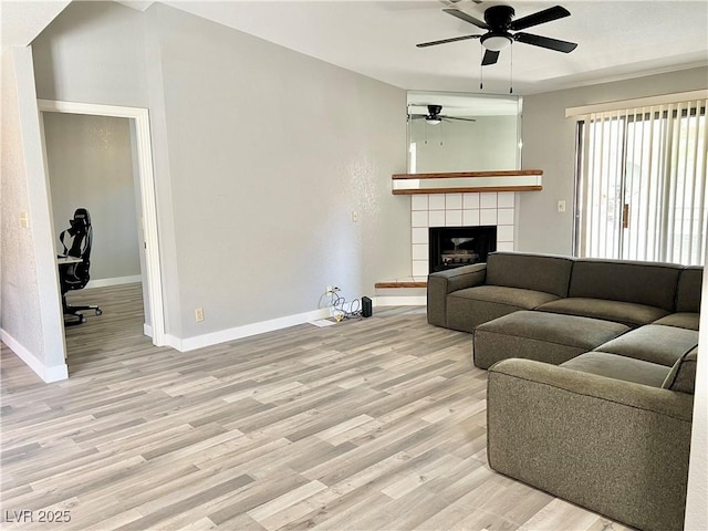 2627 S Durango Dr Unit 202, Las Vegas, NV 89117 - living area with ceiling fan, light wood-style flooring, and a fireplace
