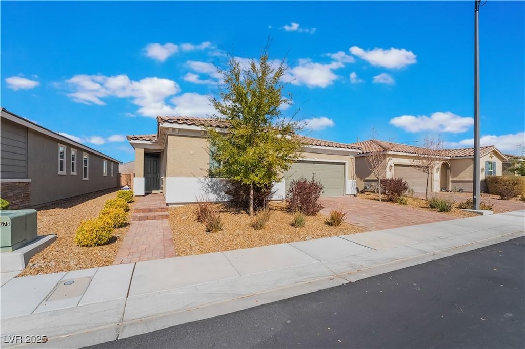 2910 Ventana Rdg, Henderson, NV 89044 - mediterranean / spanish home with a tiled roof, stucco siding, a garage, and driveway