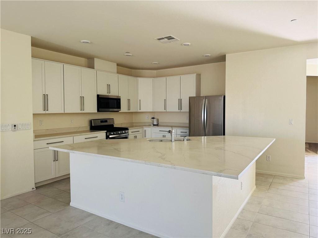 2910 Ventana Rdg, Henderson, NV 89044 - kitchen featuring stainless steel appliances, light tile patterned floors, light stone countertops, and recessed lighting