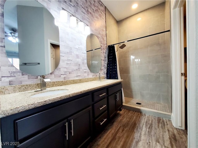 5104 Brookmere Dr, Las Vegas, NV 89130 - bathroom featuring double vanity, a tile shower, wood finished floors, and ceiling fan