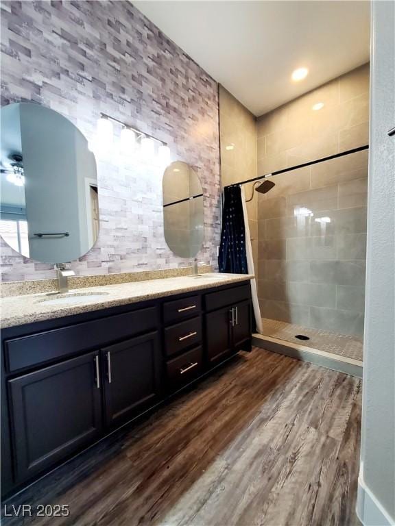 5104 Brookmere Dr, Las Vegas, NV 89130 - full bath with tiled shower, double vanity, and wood finished floors
