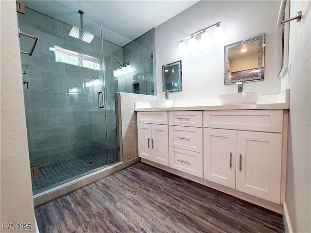 5104 Brookmere Dr, Las Vegas, NV 89130 - bathroom with wood finished floors, double vanity, and a shower stall