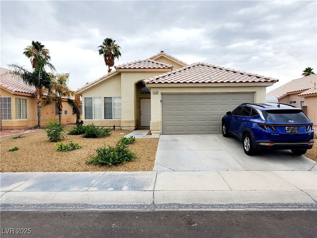 5104 Brookmere Dr, Las Vegas, NV 89130 - mediterranean / spanish house featuring an attached garage, stucco siding, concrete driveway, and a tile roof