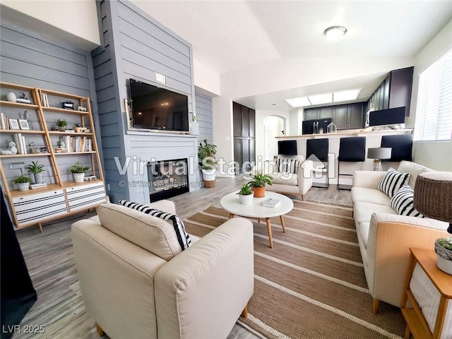 5104 Brookmere Dr, Las Vegas, NV 89130 - living room featuring a glass covered fireplace and wood finished floors