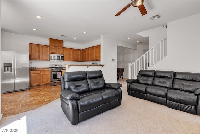 9269 Moonlight Nest Ln, Las Vegas, NV 89178 - living room with ceiling fan, recessed lighting, stairs, light carpet, and light tile patterned floors