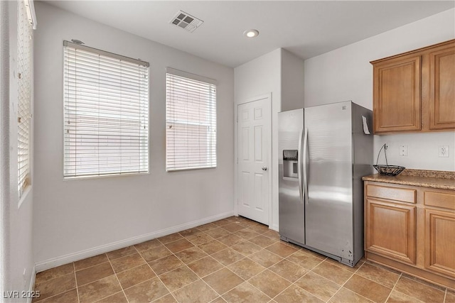9269 Moonlight Nest Ln, Las Vegas, NV 89178 - kitchen with stainless steel refrigerator with ice dispenser, brown cabinets, and recessed lighting