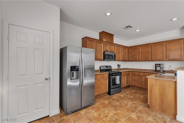 9269 Moonlight Nest Ln, Las Vegas, NV 89178 - kitchen with stainless steel appliances, brown cabinets, and recessed lighting