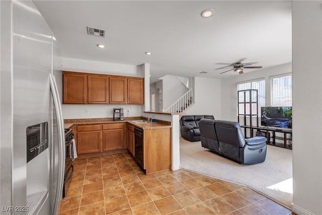 9269 Moonlight Nest Ln, Las Vegas, NV 89178 - kitchen with stainless steel refrigerator with ice dispenser, a peninsula, light colored carpet, brown cabinetry, and dishwasher