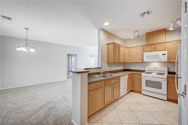 4610 Puglia Ln Unit 201, North Las Vegas, NV 89084 - kitchen featuring white appliances, light brown cabinets, recessed lighting, a peninsula, and hanging light fixtures