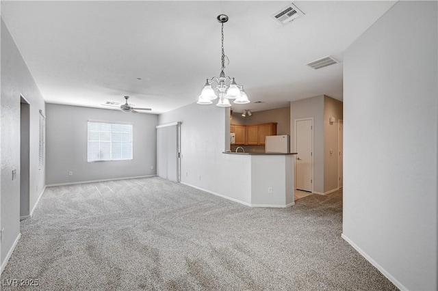 4610 Puglia Ln Unit 201, North Las Vegas, NV 89084 - unfurnished living room with light colored carpet, a ceiling fan, and a chandelier