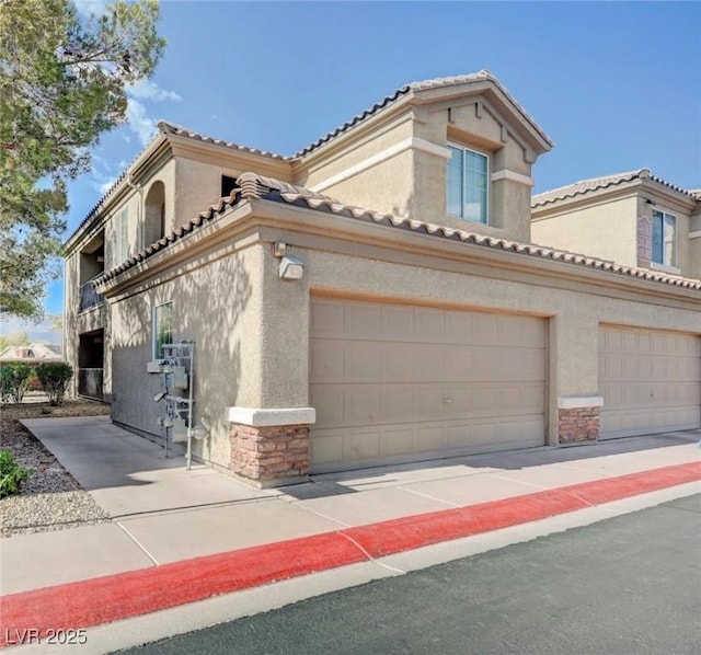 4610 Puglia Ln Unit 201, North Las Vegas, NV 89084 - mediterranean / spanish-style home featuring stone siding, stucco siding, and a tile roof