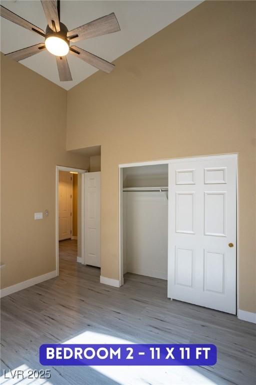 9710 Geiger Peak Ct, Las Vegas, NV 89148 - unfurnished bedroom with high vaulted ceiling, light wood-style floors, a closet, and a ceiling fan