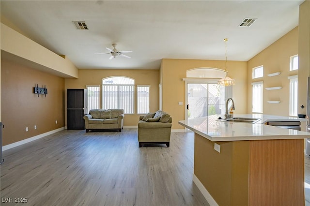 9710 Geiger Peak Ct, Las Vegas, NV 89148 - kitchen featuring plenty of natural light, light wood-type flooring, ceiling fan, and light countertops