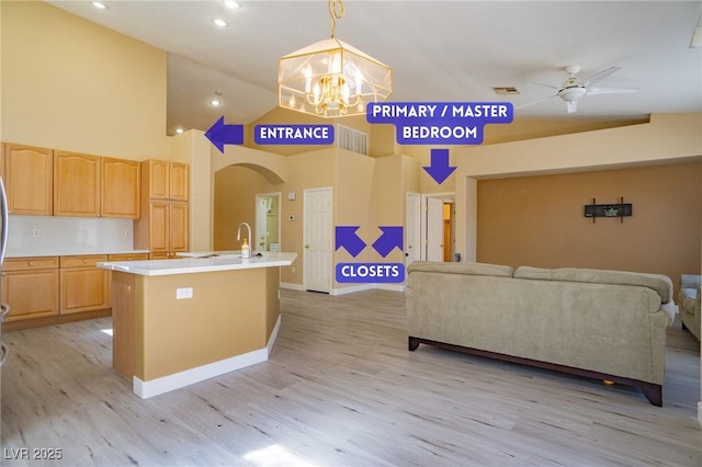 9710 Geiger Peak Ct, Las Vegas, NV 89148 - kitchen with open floor plan, light wood-style flooring, a chandelier, a ceiling fan, and light countertops