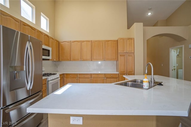 9710 Geiger Peak Ct, Las Vegas, NV 89148 - kitchen with white appliances, arched walkways, a high ceiling, light countertops, and a large island with sink