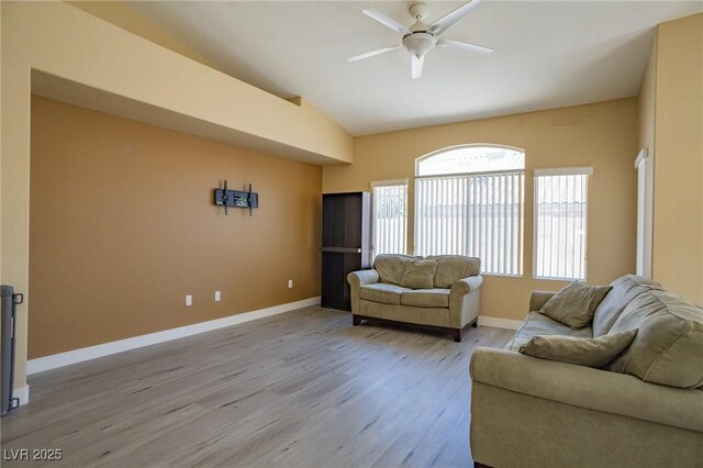 9710 Geiger Peak Ct, Las Vegas, NV 89148 - living room featuring vaulted ceiling, ceiling fan, and light wood-style flooring