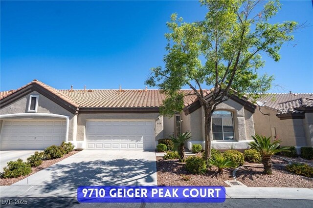 9710 Geiger Peak Ct, Las Vegas, NV 89148 - single story home featuring an attached garage, driveway, a tile roof, and stucco siding