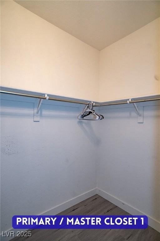 9710 Geiger Peak Ct, Las Vegas, NV 89148 - walk in closet featuring wood finished floors