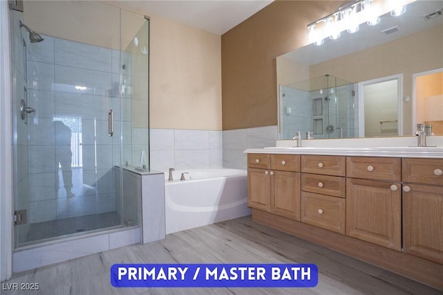 9710 Geiger Peak Ct, Las Vegas, NV 89148 - full bath featuring wood finished floors, a shower stall, and double vanity