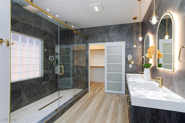 85 Alerion St, Las Vegas, NV 89138 - bathroom with wood finished floors, tile walls, a stall shower, and double vanity