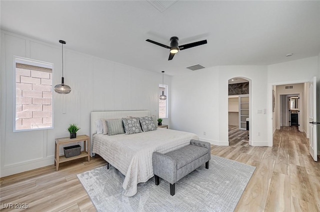 85 Alerion St, Las Vegas, NV 89138 - bedroom with arched walkways, light wood-style flooring, and multiple windows