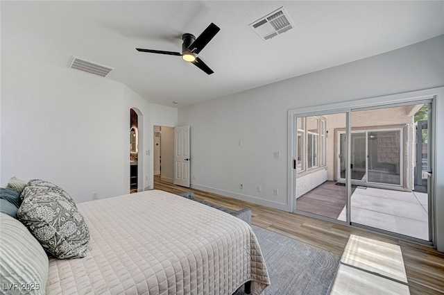 85 Alerion St, Las Vegas, NV 89138 - bedroom featuring access to exterior, wood finished floors, arched walkways, and a ceiling fan