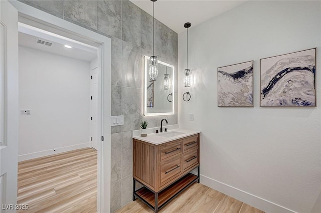 85 Alerion St, Las Vegas, NV 89138 - bathroom featuring wood finished floors, vanity, and tile walls