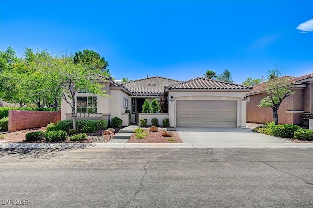 85 Alerion St, Las Vegas, NV 89138 - mediterranean / spanish house featuring stucco siding, a tile roof, concrete driveway, and an attached garage