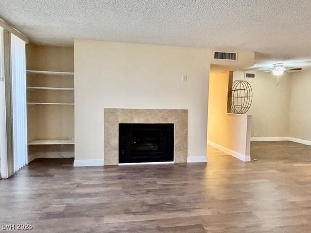 750 S Royal Crest Cir Unit 325, Las Vegas, NV 89169 - unfurnished living room featuring wood finished floors, a textured ceiling, a premium fireplace, and ceiling fan