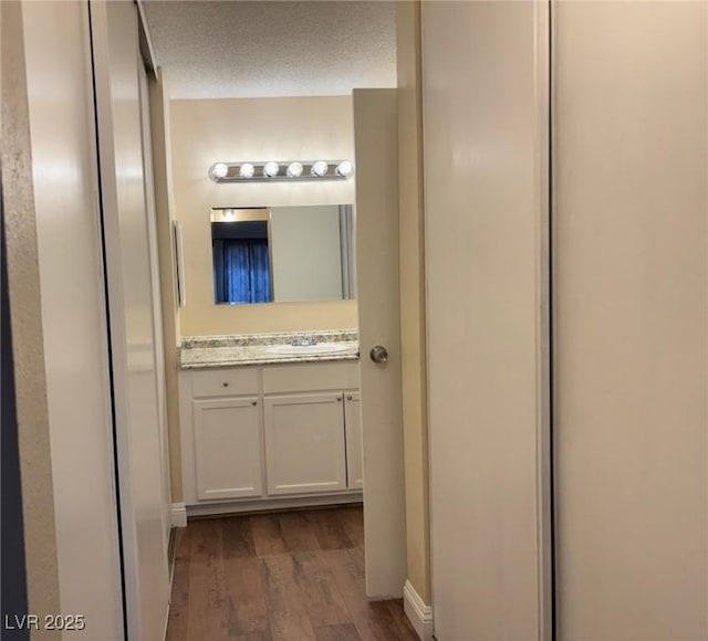 750 S Royal Crest Cir Unit 325, Las Vegas, NV 89169 - bathroom with vanity, wood finished floors, and a textured ceiling
