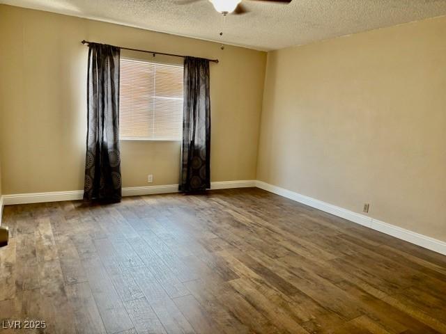 750 S Royal Crest Cir Unit 325, Las Vegas, NV 89169 - unfurnished room with ceiling fan, dark wood-style floors, and a textured ceiling