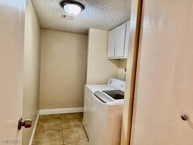 750 S Royal Crest Cir Unit 325, Las Vegas, NV 89169 - laundry area with separate washer and dryer, cabinet space, light tile patterned flooring, and a textured ceiling