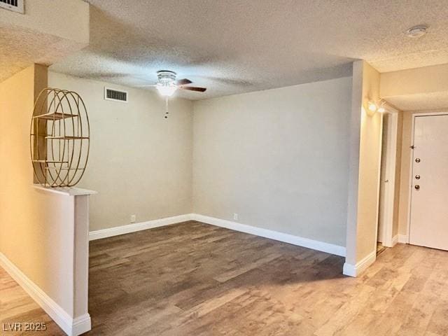 750 S Royal Crest Cir Unit 325, Las Vegas, NV 89169 - empty room featuring ceiling fan, wood finished floors, a textured ceiling, and a smoke detector