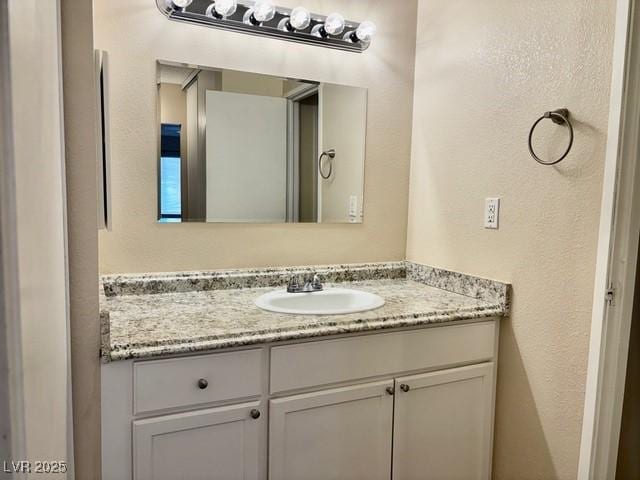 750 S Royal Crest Cir Unit 325, Las Vegas, NV 89169 - bathroom with vanity and a textured wall