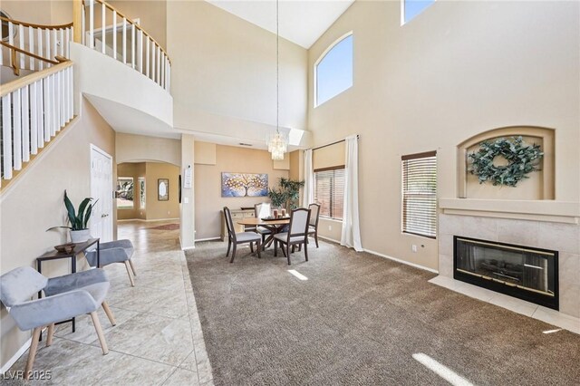 5434 Lost Ln, Las Vegas, NV 89118 - dining space with arched walkways, stairs, healthy amount of natural light, a high ceiling, and a fireplace