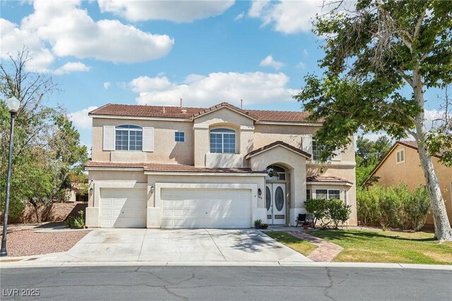 5434 Lost Ln, Las Vegas, NV 89118 - mediterranean / spanish home with an attached garage, concrete driveway, stucco siding, a tile roof, and a front lawn