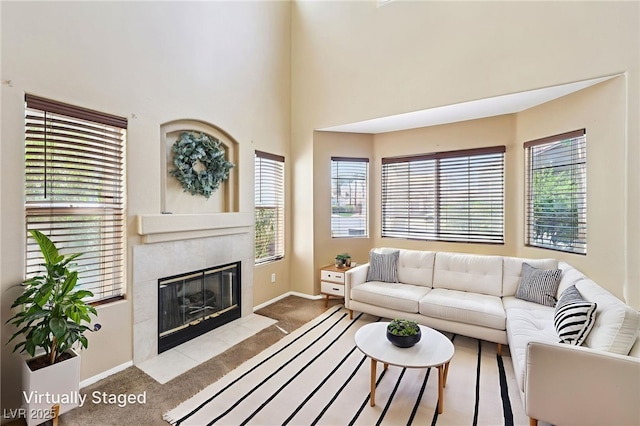5434 Lost Ln, Las Vegas, NV 89118 - carpeted living room featuring a tile fireplace and baseboards