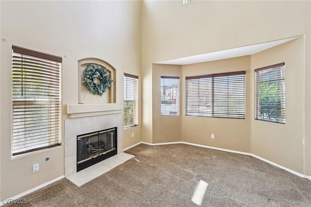 5434 Lost Ln, Las Vegas, NV 89118 - unfurnished living room with carpet floors and a tiled fireplace