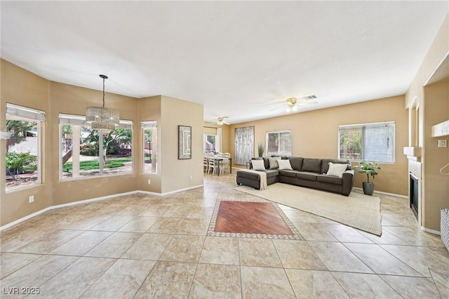 5434 Lost Ln, Las Vegas, NV 89118 - living room featuring light tile patterned floors, a chandelier, ceiling fan, and a fireplace