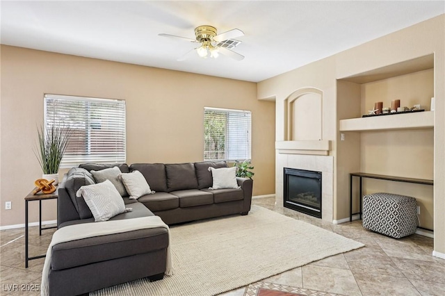 5434 Lost Ln, Las Vegas, NV 89118 - living room featuring a ceiling fan, a tiled fireplace, and light tile patterned floors