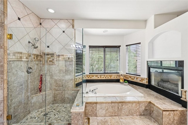 5434 Lost Ln, Las Vegas, NV 89118 - bathroom featuring a garden tub, a stall shower, a tile fireplace, and recessed lighting