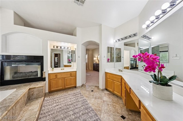 5434 Lost Ln, Las Vegas, NV 89118 - bathroom with a glass covered fireplace and two vanities