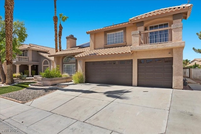 2842 Via Florentine St, Henderson, NV 89074 - mediterranean / spanish home featuring stucco siding, concrete driveway, roof mounted solar panels, a tile roof, and a garage