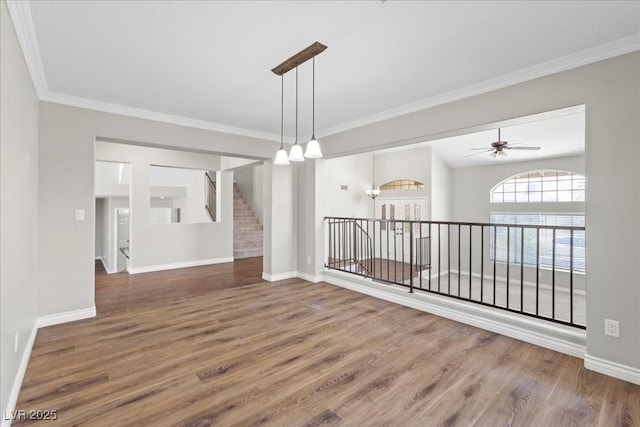 2842 Via Florentine St, Henderson, NV 89074 - spare room with wood finished floors, crown molding, a ceiling fan, and stairway