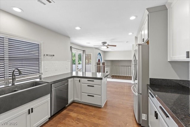 2842 Via Florentine St, Henderson, NV 89074 - kitchen featuring stainless steel appliances, a peninsula, wood finished floors, recessed lighting, and a ceiling fan