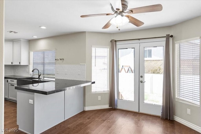 2842 Via Florentine St, Henderson, NV 89074 - kitchen with dark countertops, french doors, a peninsula, dark wood-type flooring, and recessed lighting