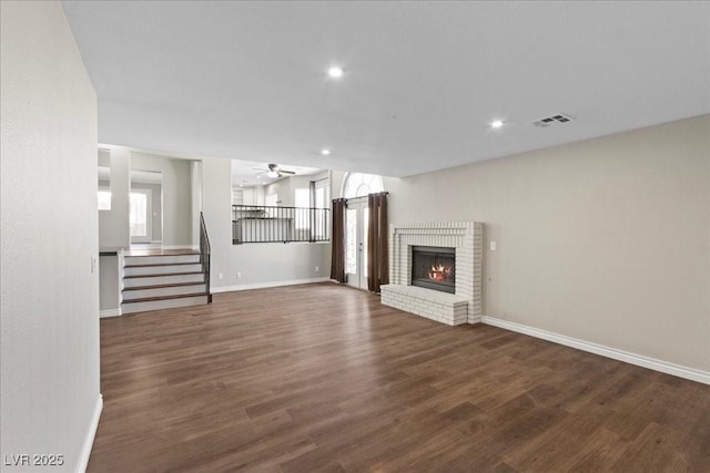 2842 Via Florentine St, Henderson, NV 89074 - unfurnished living room featuring a ceiling fan, wood finished floors, stairway, recessed lighting, and a fireplace