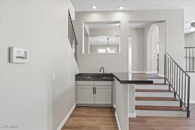 2842 Via Florentine St, Henderson, NV 89074 - bar with wood finished floors, stairway, a ceiling fan, recessed lighting, and arched walkways