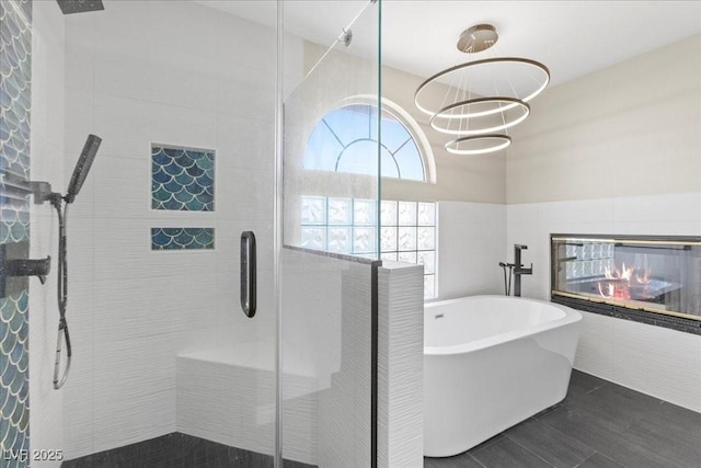 2842 Via Florentine St, Henderson, NV 89074 - full bath featuring a stall shower, a freestanding bath, a multi sided fireplace, and a chandelier